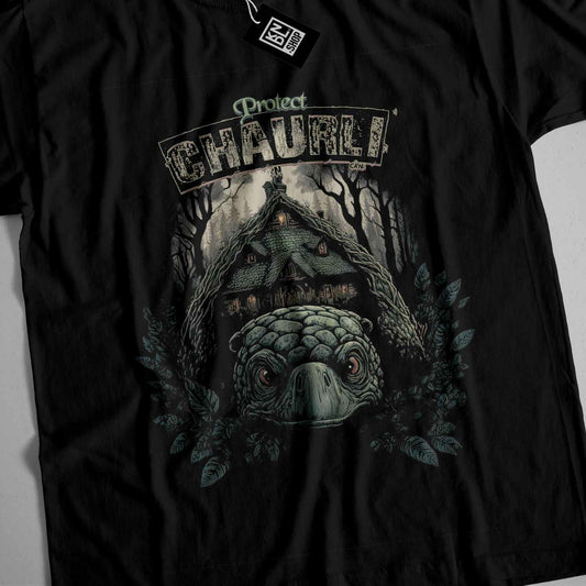 a black t - shirt with a picture of a house in the woods