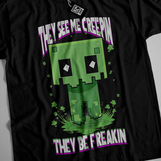 a black t - shirt with an image of a creepin