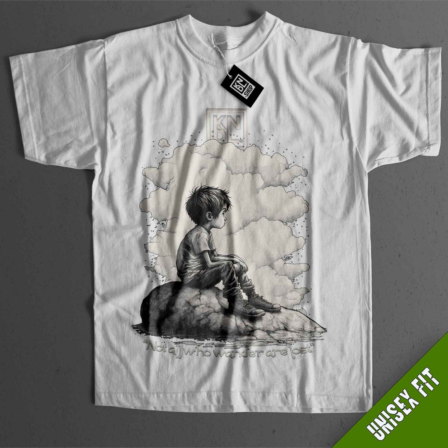 a t - shirt with a picture of a boy sitting on a rock